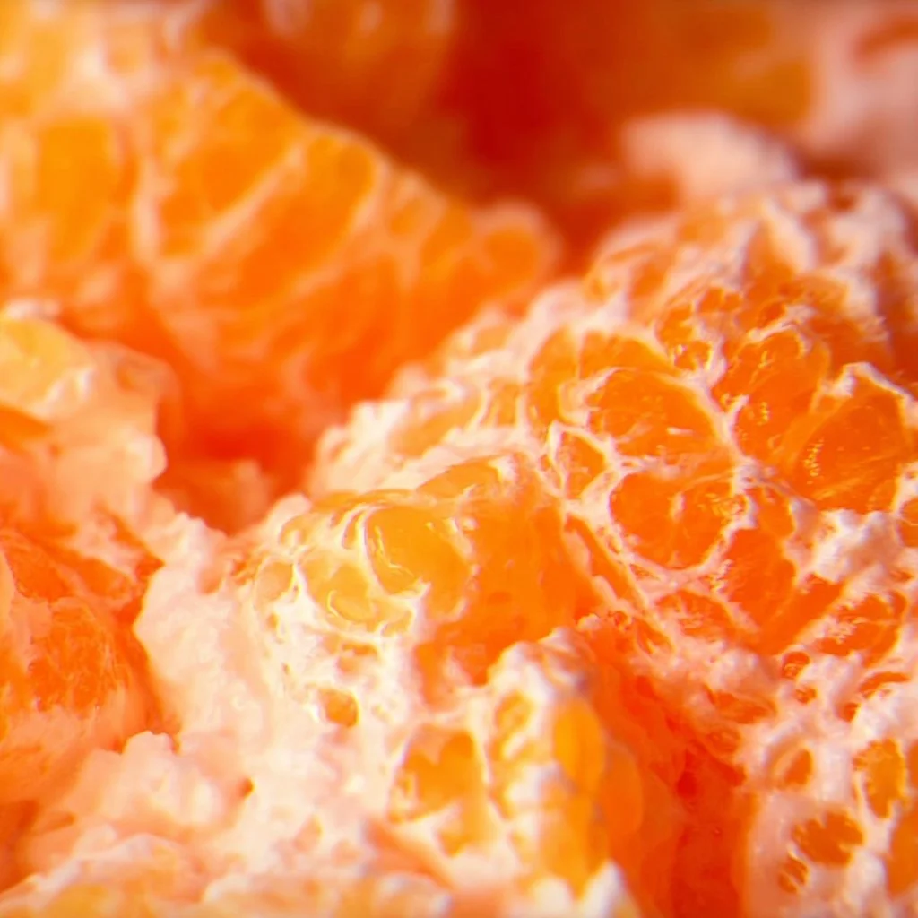 Delicious Mandarin Orange Jello Salad served in a bowl with fresh oranges