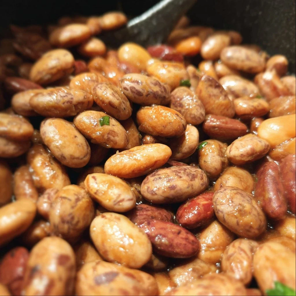 Vegan Mexican pinto beans served in a colorful bowl with spices and herbs.