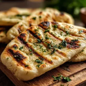 Air Fryer Garlic Flatbread served on a wooden board with herbs.