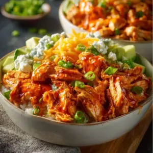 Delicious Buffalo Chicken Bowls topped with fresh ingredients and spicy sauce